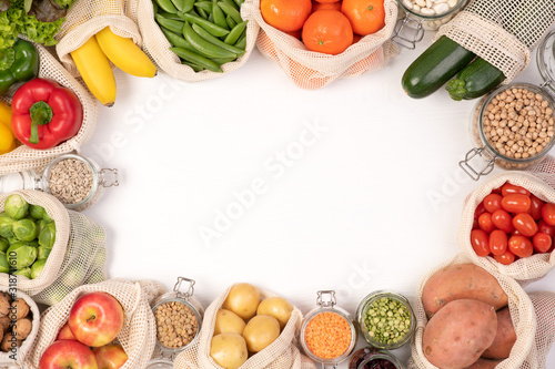 Fototapeta Naklejka Na Ścianę i Meble -  Zero waste concept. Fruits and vegetables in eco friendly reusable cotton bags. Top view with copy space