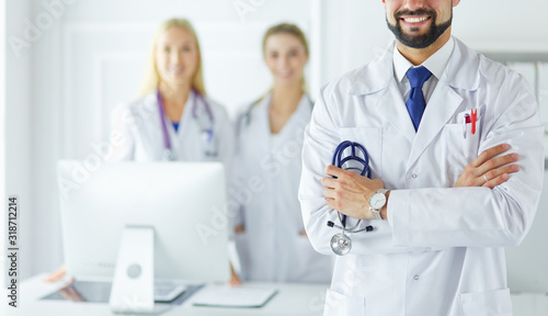 Young male doctor in front of medical group