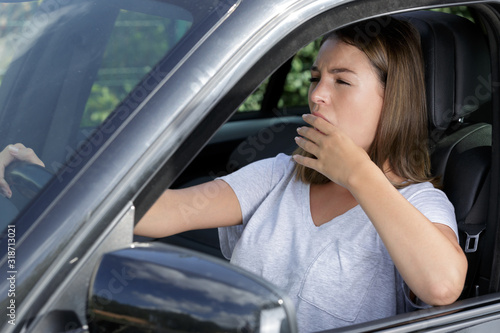 sleepy woman while driving her car