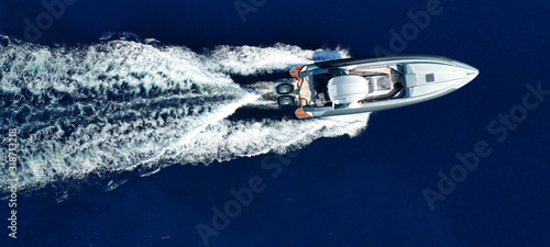 Aerial drone top view ultra wide photo of luxury inflatable rib speed boat cruising in mediterranean deep blue sea © aerial-drone