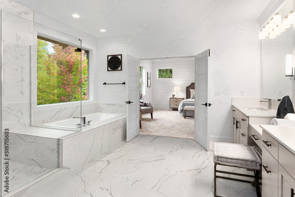 View of Master bathroom interior in new luxury home with marble floors and wall ...