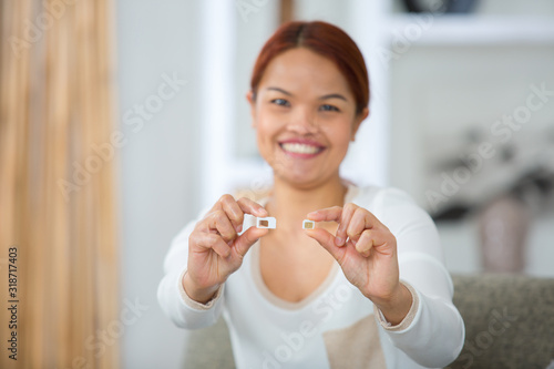 smiling woman showing sim cards
