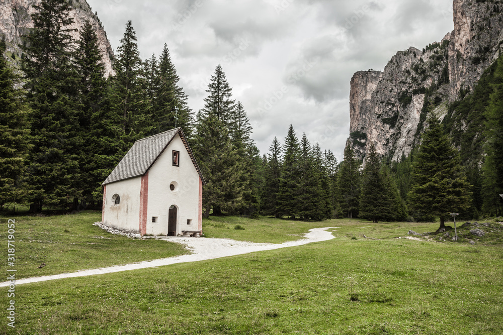 An isolated little chapel (St. Silvester) among the woods in the Italian Dolomites
