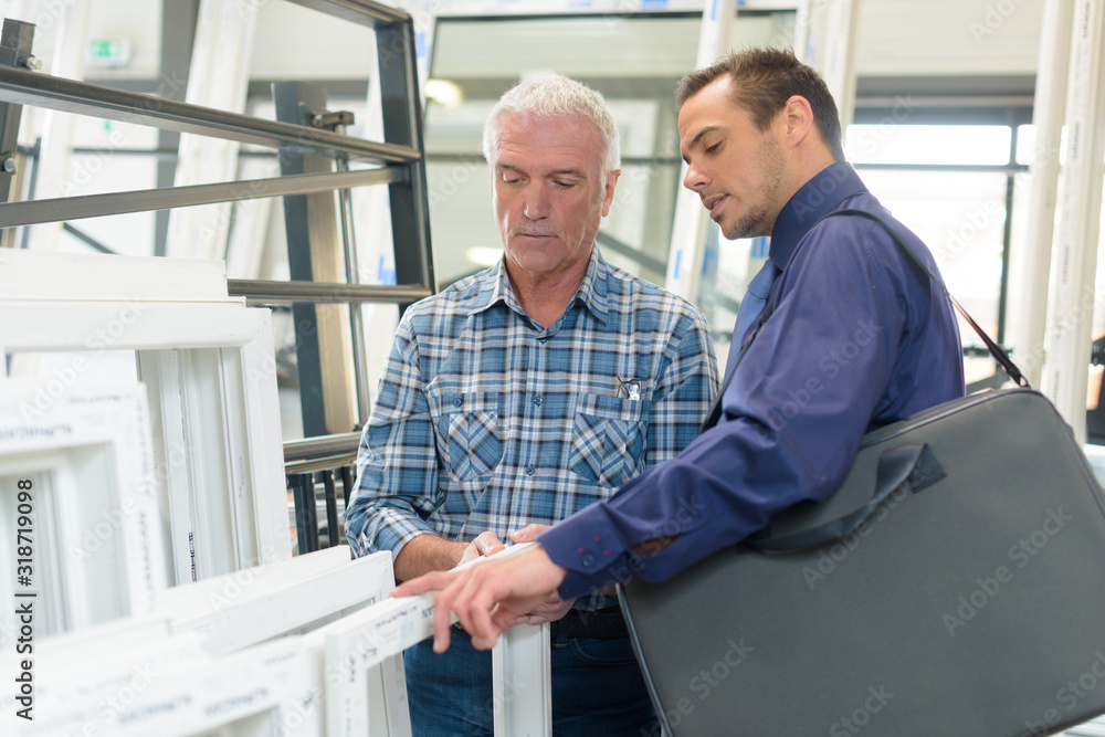 Fototapeta premium salesman with worker in double glazing premises