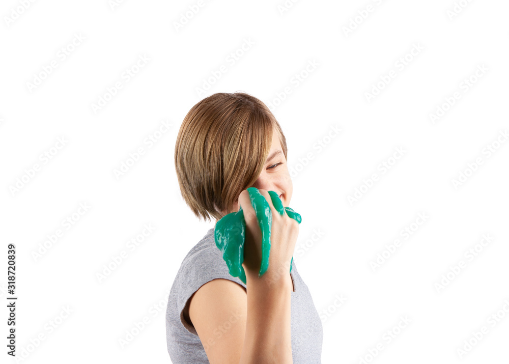 Green slime squeezed in young girl hand. Studio shot isolated on white. Focused on the girl. Green slime squeezed in young girl hand. Studio shot isolated on white. Focused on the girl.