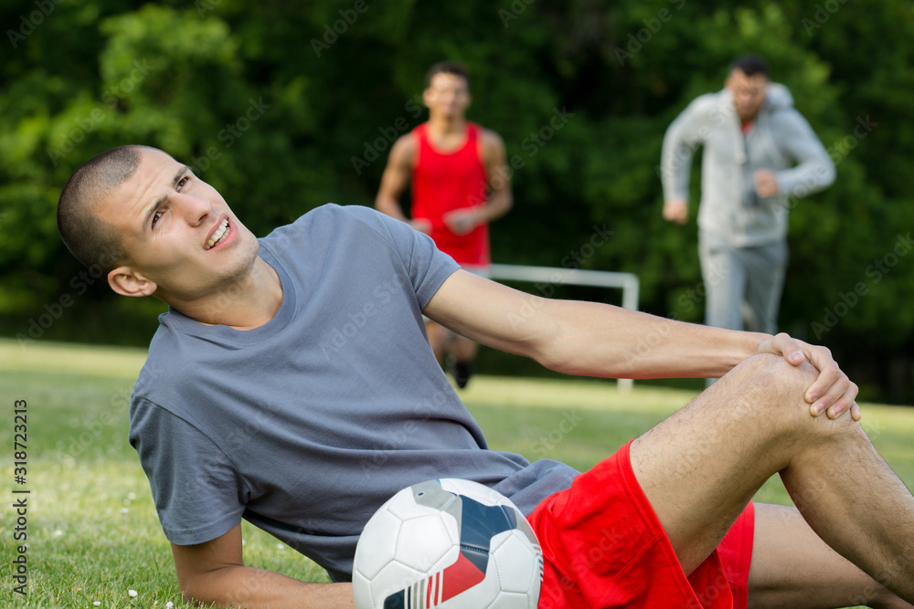 young football player suffers a knee injury