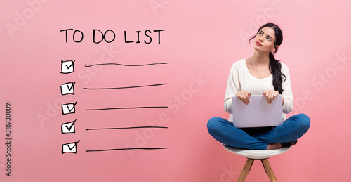 Cuadro en lienzo To do list with young woman using a laptop computer