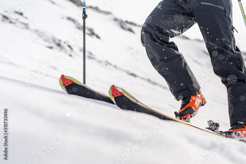 skier sticking climbing skins on splitboard. Ski touring equipment.