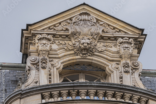 Old French house with traditional balconies and windows. Paris, France.