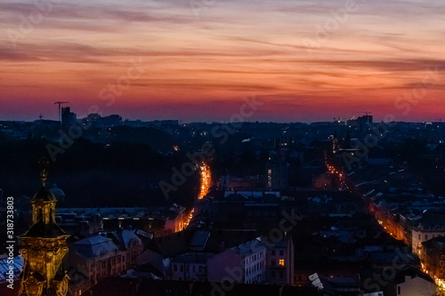View on illuminated Latin cathedral and historic center of the Lviv at sunset. View on Lvov cityscape from the town hall