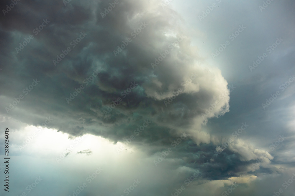Naklejka premium big bright thundercloud in a gray dark blue stormy sky