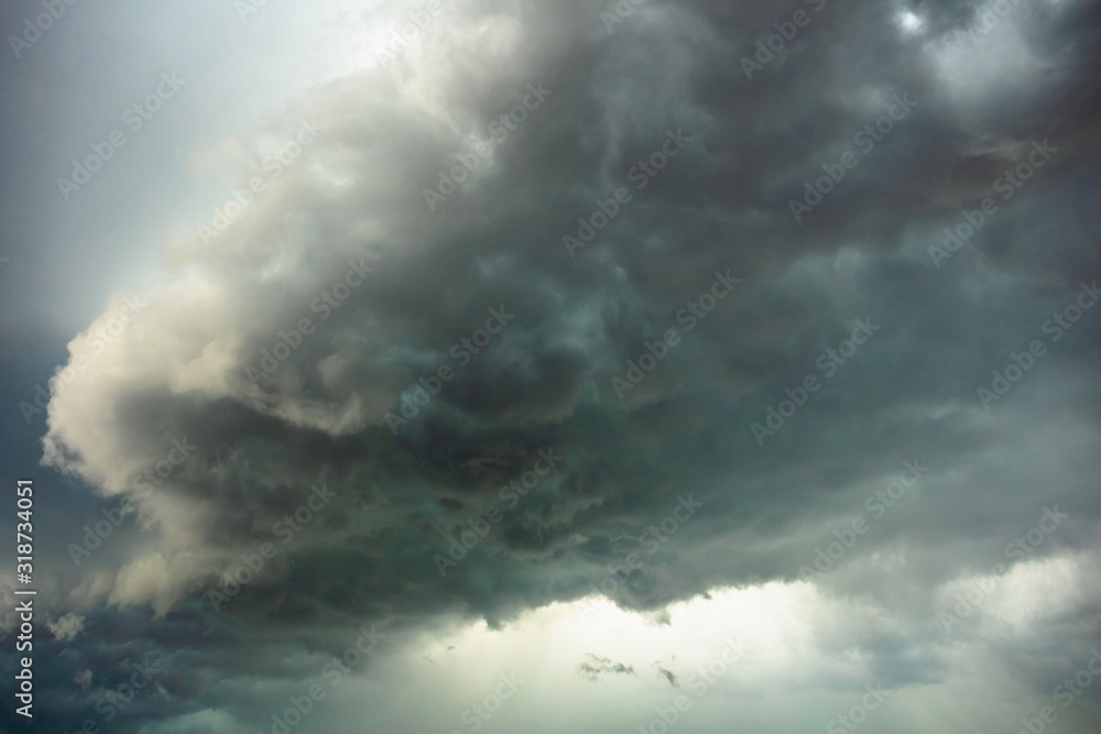 big bright thundercloud in a gray dark blue stormy sky big bright thundercloud in a gray dark blue stormy sky