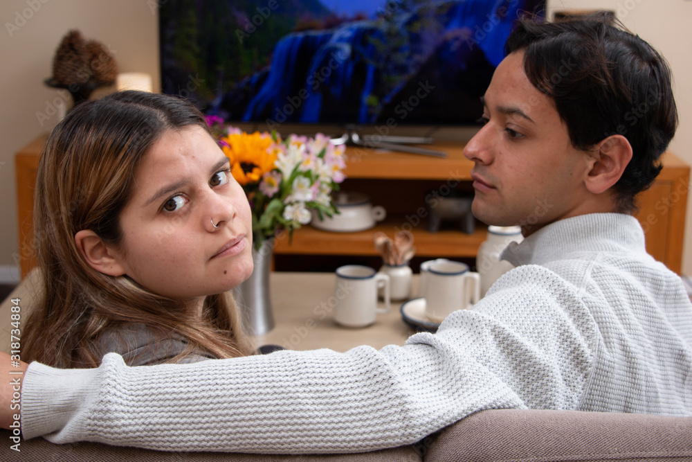 Nice ethnic couple watching TV at home Nice ethnic couple watching TV at home