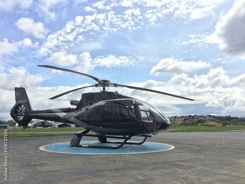 Large executive helicopter parked at airport awaiting businessman