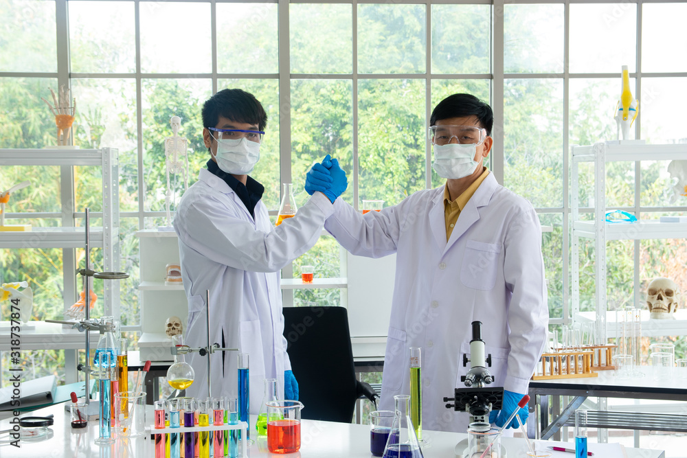 Scientists or doctors are testing bloods to prevent and destroy new strains of the virus through tube and beaker. Researching and experimenting for effective chemicals. Successful teamwork concept. Scientists or doctors are testing bloods to prevent and destroy new strains of the virus through tube and beaker. Researching and experimenting for effective chemicals. Successful teamwork concept.