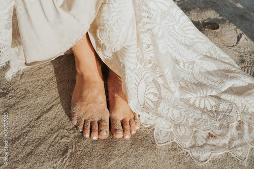 bride white wedding on the beach with barefeet