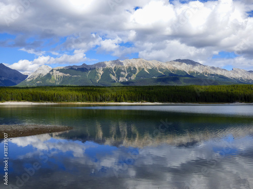 Mountains and clouds reflected in serene Lower Kananaskis Lake © Lucille Ryan Images