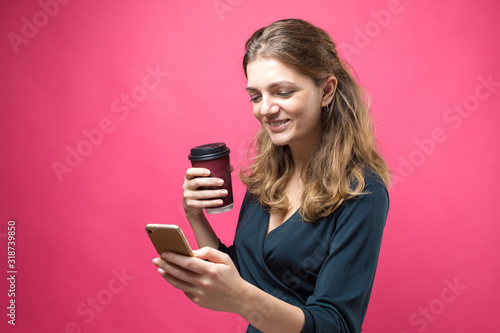Glamor woman with a drink of coffee on a pink background.