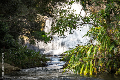 Natural water cascade hidden in the jungle forest during sunny day, Diyaluma Falls, Sri Lanka photo