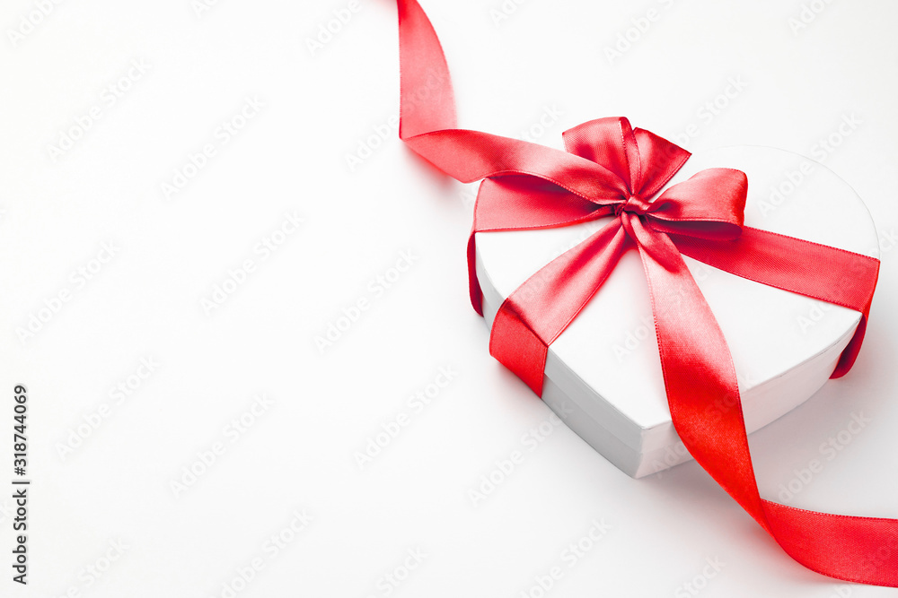 Heart gift box for Valentines day. White gift box with bow and red ribbon heart, photo template, background. Heart gift box for Valentines day. White gift box with bow and red ribbon heart, photo template, background.
