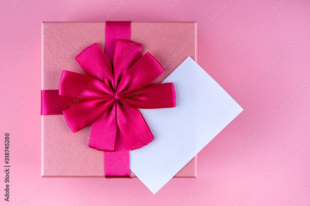 Present with note with red heart on pink background mock up, copyspace Present with note with red heart on pink background mock up, copyspace