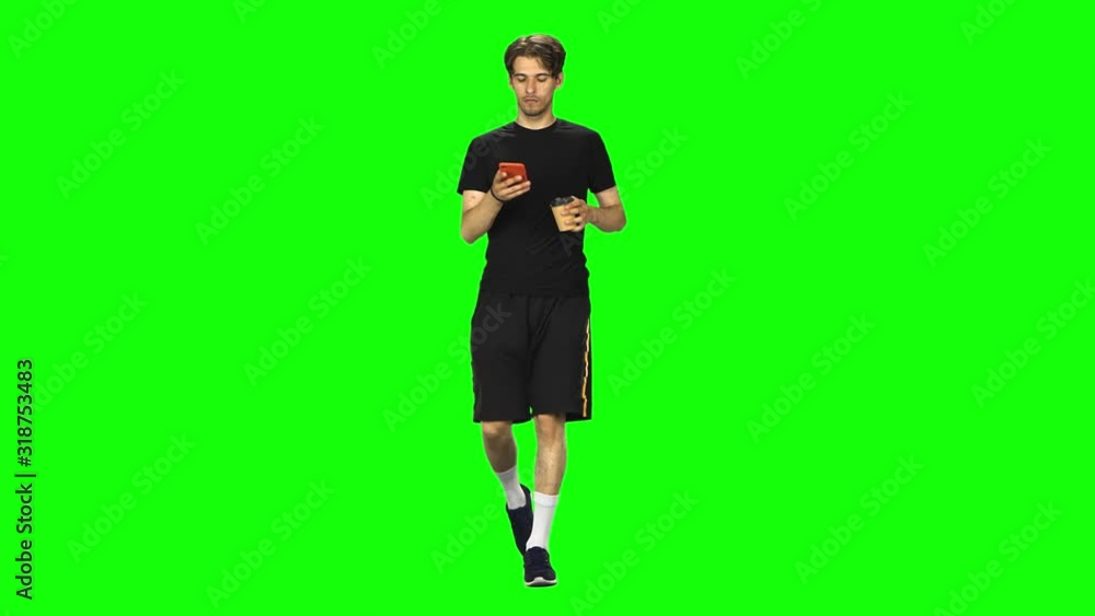 Brunette man walking and watching on the phone something, drinking coffee. Chroma Key Brunette man walking and watching on the phone something, drinking coffee. Chroma Key