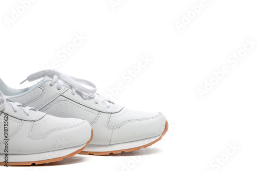Toes of New White Modern Trainers Placed over Over White Background.