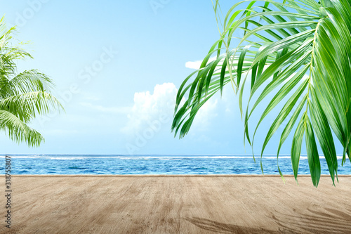 Wooden floor with oceanview and green palm leaf