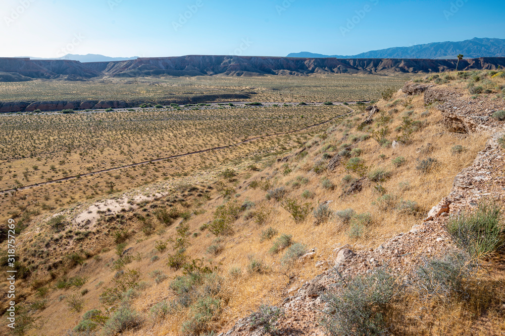 USA, Nevada, Clark County, Mesquite. The morning sun rises over Flat Top Mesa and shines into Toquop Wash.