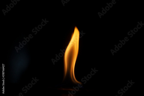 Tongue of fire flame in the dark. Ignition of oxygen in space. Fiery background. Fire of ether in the absence of light. Abstract fire heat background. Single fire. The ignition gel is on.