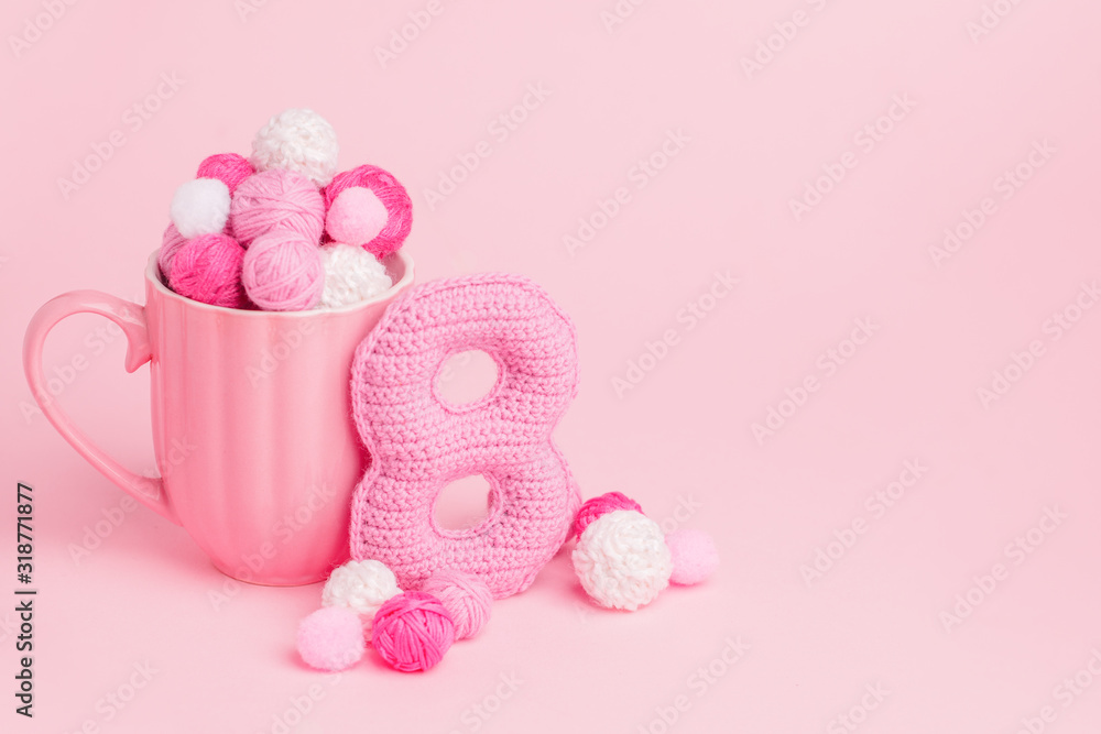 8 March symbol. Figure of eight made of handmade crochet. Happy womans day design. Decorative greeting grungy hobby card or postcard for international Woman's Day 8 March. Birthday for girl, banner 8 March symbol. Figure of eight made of handmade crochet. Happy womans day design. Decorative greeting grungy hobby card or postcard for international Woman's Day 8 March. Birthday for girl, banner