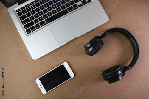 Audio, video and photography business office with equipment such as laptop, mobile phone, headphones and camera with photographic accessories