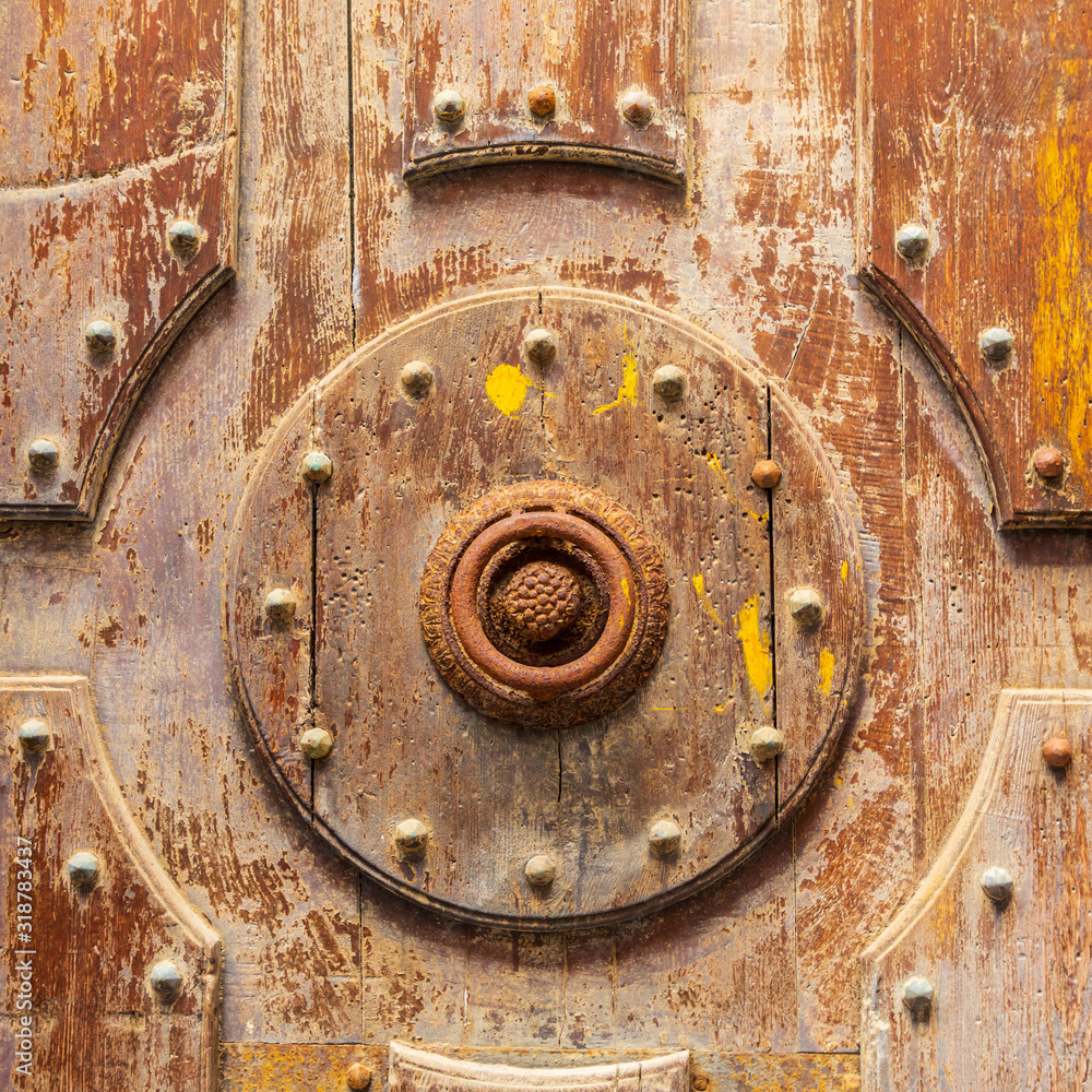 Italy, Sicily, Palermo Province, Cefalu. Detail of an exterior wooden door on the Cefalu Cathedral, a UNESCO World Heritage site.