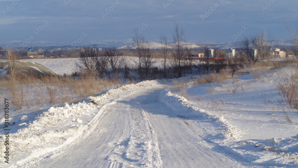 Winter road background. White snow. Country road. Ust-Kamenogorsk (Kazakhsan). City outskirts