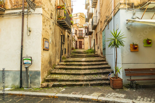 Fototapeta Naklejka Na Ścianę i Meble -  Italy, Sicily, Palermo Province, Castelbuono. Stairs on a narrow side street in the town of Castelbuono.