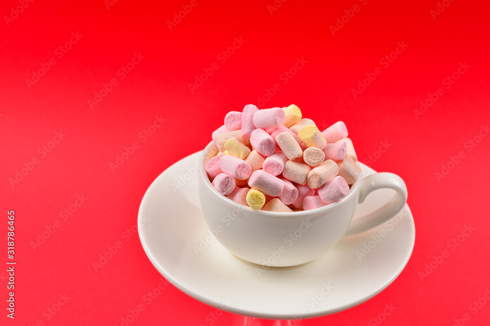 Cup with marshmallow on a red background. Copy space. Cup with marshmallow on a red background. Copy space.