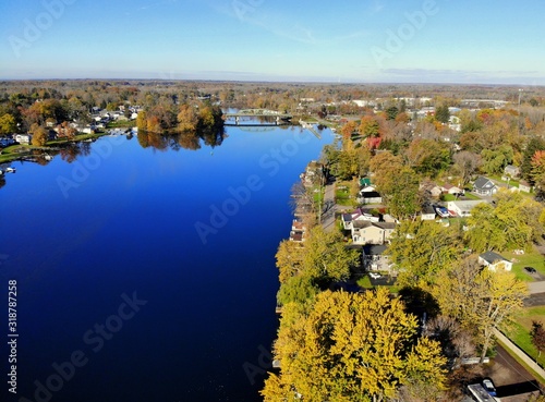 The aerial view of the waterfront homes by Oneida Lake with stunning fall foliage near Syracuse, New York, U.S.A