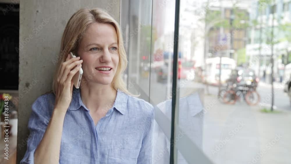 Happy businesswoman making phone call in coffee shop Happy businesswoman making phone call in coffee shop