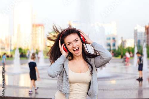 Girl listening to music streaming with headphones. © Smile