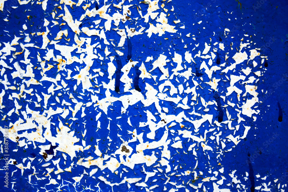 Fototapeta premium Abstract background of peeling white paint on a blue wall, rust on a cold wall