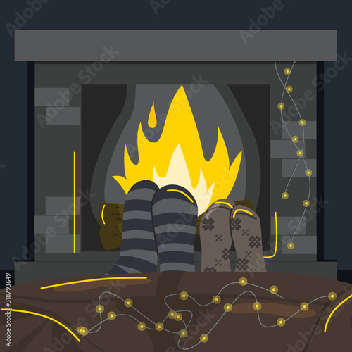 Couple relaxes in front of burning fireplace