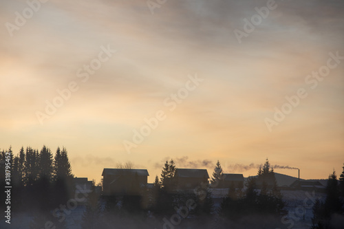 view of sunrise at mountains village. building with chimney