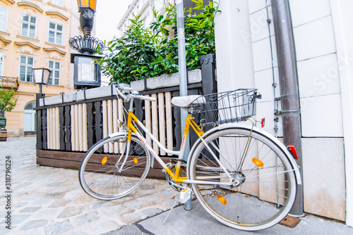 Photography old retro yellow bike at european city street