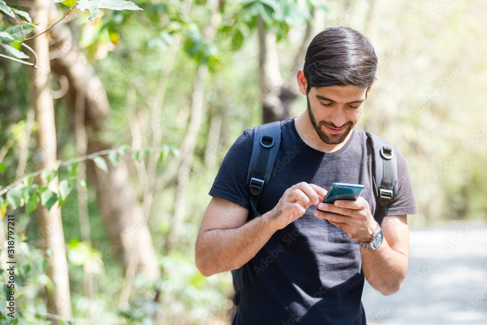 young man using mobile smartphone, travel autumn forest. young man using mobile smartphone, travel autumn forest.