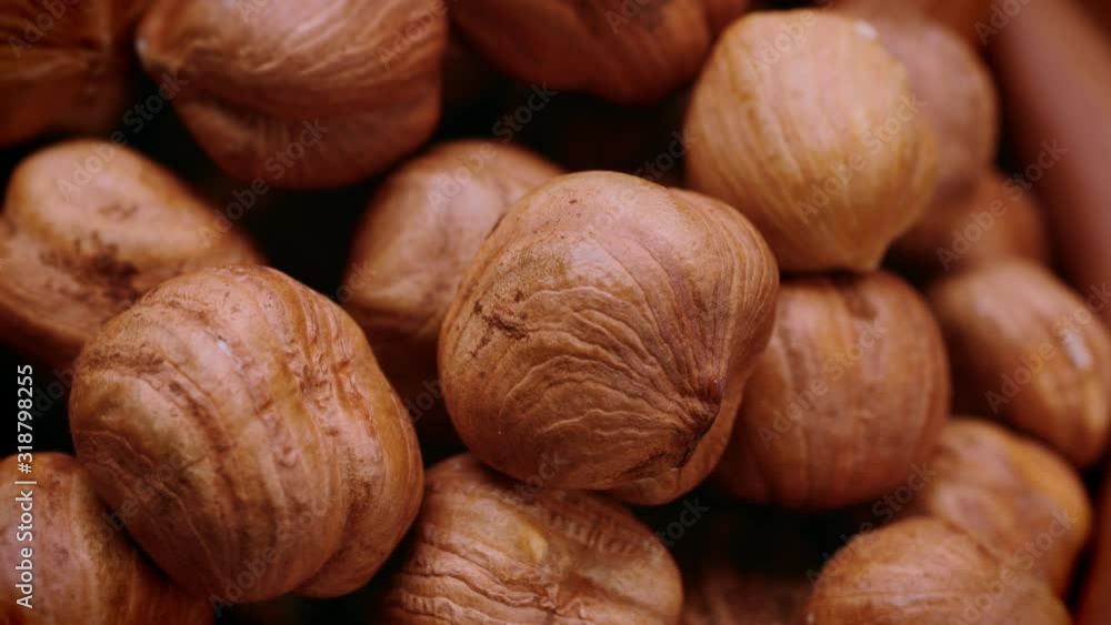 Peeled grains of hazelnuts in an earthenware bowl. Close-up. Slow rotation. 4k video. Peeled grains of hazelnuts in an earthenware bowl. Close-up. Slow rotation. 4k video.