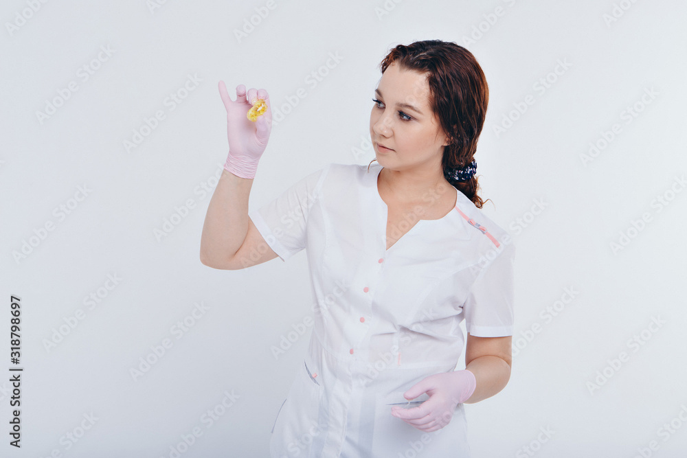 wax for depilation close-up. The girl demonstrates a cosmetic product. The doctor's gloved hand. Sugaring: hair removal with liquid sugar. This is a less painful hair removal with wax replacement wax for depilation close-up. The girl demonstrates a cosmetic product. The doctor's gloved hand. Sugaring: hair removal with liquid sugar. This is a less painful hair removal with wax replacement