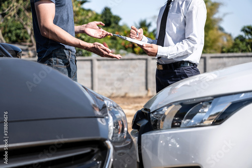 Insurance Agent examining car crash and customer assessed negotiation, checking and signing on report claim form process after accident collision, Accident and insurance concept