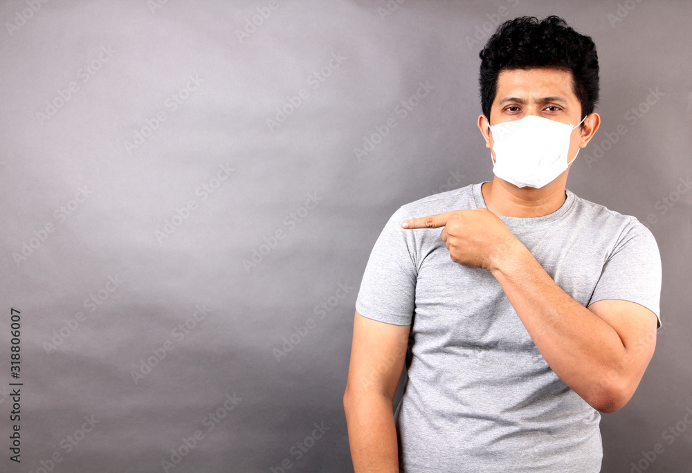 Asian man wearing a mask is sick isolated on gray background in studio.
