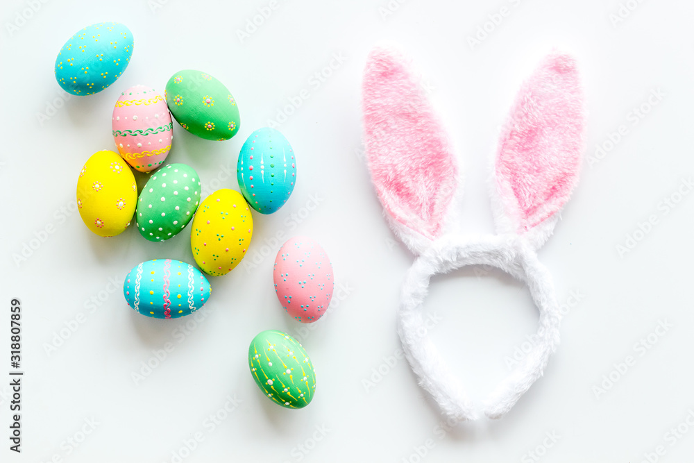 Easter symbols. Bunny and painted eggs on white background top-down Easter symbols. Bunny and painted eggs on white background top-down