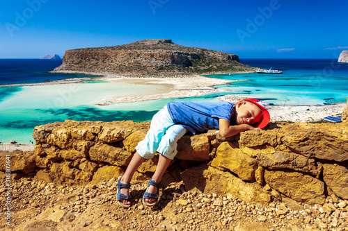 Balos lagoon on Crete island, Greece. Tourists relax and bath in crystal clear water of Balos beach. The most unique natural attraction in Crete.